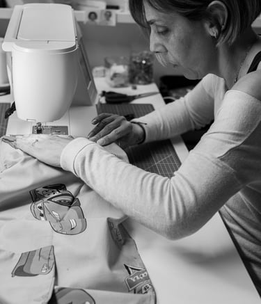 a woman is sewinging a dress on a sewing machine