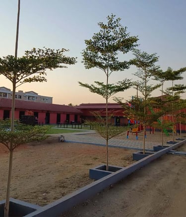 Hotel exterior featuring lush green design for guest relaxation by Garden Designers