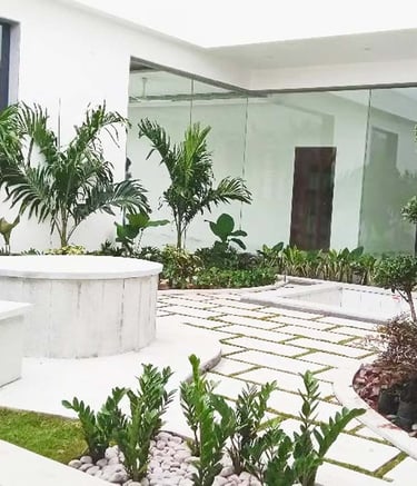 Rustic courtyard with clay pots and decorative planters by Garden Designers