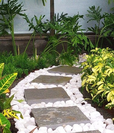 Lush indoor courtyard merging into an outdoor garden by Garden Designers