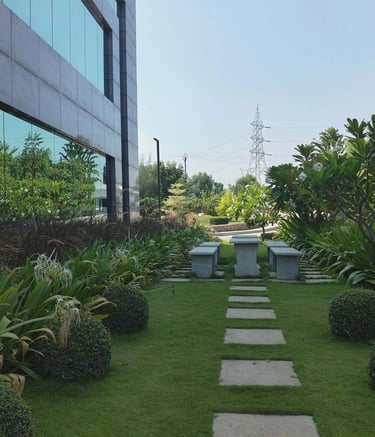 Campus landscape designed with sustainable plantings and gathering spaces by Garden Designers