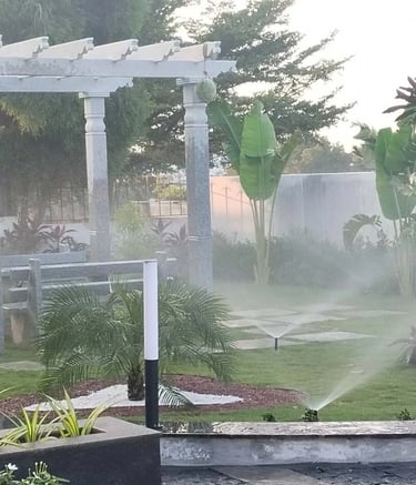 Efficient drip irrigation setup in a well-designed garden by Garden Designers