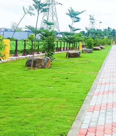 Plot development entrance with landscaped signage and driveways by Garden Designers