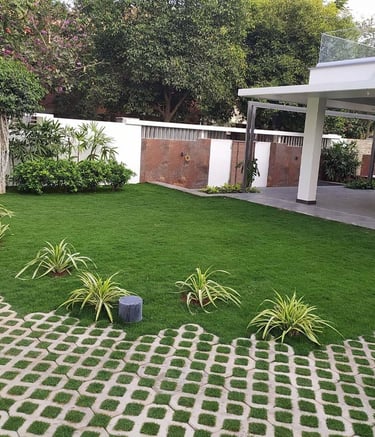 Modern residential garden with layered planting and cozy seating zones by Garden Designers