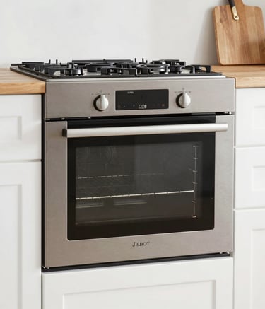 A white laundry area with a washing machine featuring a Samsung logo. On top of the machine is a blue spray bottle. To the left, there is a striped laundry basket. The walls are tiled, and there is a hose attached to the wall. Sunlight casts shadows creating a grid pattern on the surfaces.