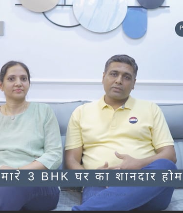 a man and woman sitting on a couch in a living room