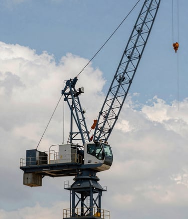 A professional commercial crane operating in a modern industrial setting in Cordoba, bright daylight, Steel Blue Grey metal accents, Soft Off-White clouds in the distance, sharp focus photography.