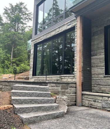 Modern home exterior featuring square pattern stone veneer walls.