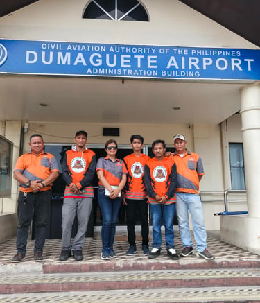 Jansen Pest Control posing at Dumaguete Airport Administration Building in the Philippines.
