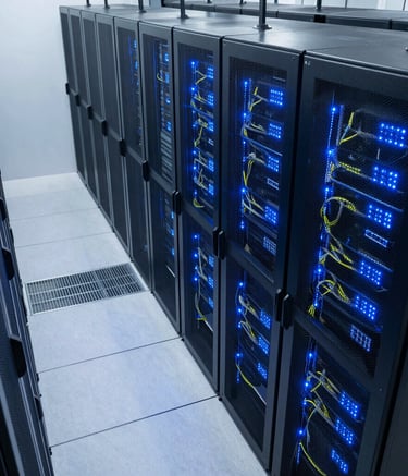 A high-angle perspective shot looking down a data center aisle with rows of server racks, glowing blue LED status lights, and professional cable management. The environment is clean and modern with cool white lighting in a Global tech facility.