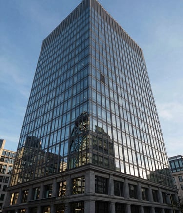 Wide-angle photography of a majestic, glass-fronted financial headquarters in London. The building reflects the clear blue sky, emphasizing trust, transparency, and the firm's long-standing presence in the city.