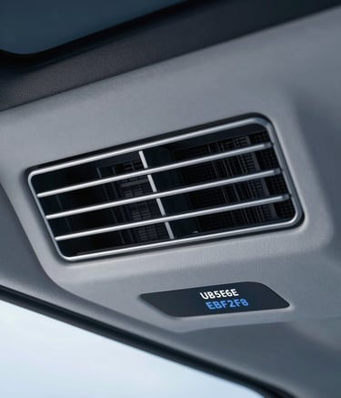 A close-up, high-detail shot of a custom-installed air conditioning vent and digital control panel inside a modified Urbania. The scene conveys precision engineering and modern luxury, featuring clean lines and metallic accents. Lighting is soft and focused, incorporating the brand colors #3F5B6D and #EBF2F6.