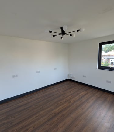 Plastered Garden Room with wood laminate flooring, white walls, and a black sputnik ceiling light.