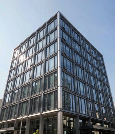 Architectural photography of a sleek, modern commercial building facade with glass and steel, located in a North American urban area. Bright, clear sky and professional atmosphere.