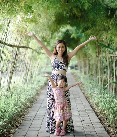 Lifestyle portrait of woman at Padma Resort Legian Bali surrounded by tropical greenery and soft natural light.