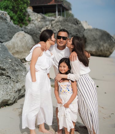 Family portrait near the rocks at Karma Kandara beach Bali  