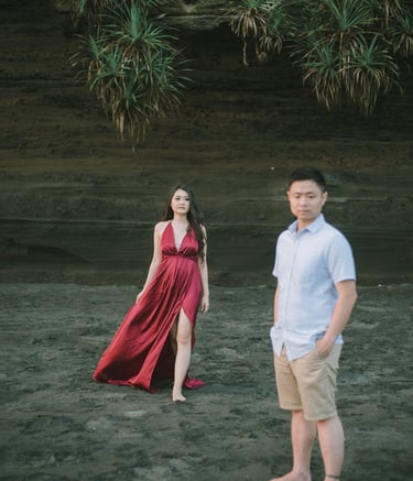 Woman walking on rock cliff during intimate couple session at Pantai Nyanyi Bali.