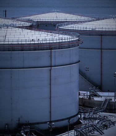 "Commercial fuel storage tanks with access platforms and industrial piping"