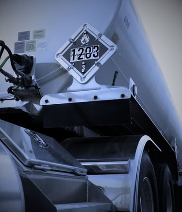 "DOT hazmat truck with 1203 gasoline placard for flammable liquid transportation"