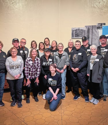 A group of volunteers smiling together for a group photo