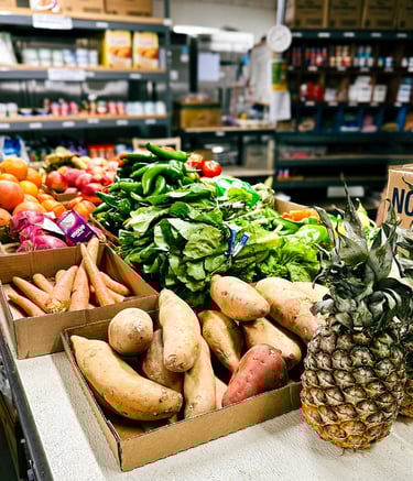 Pantry interior with table of fresh produce and shelves with canned and boxed food