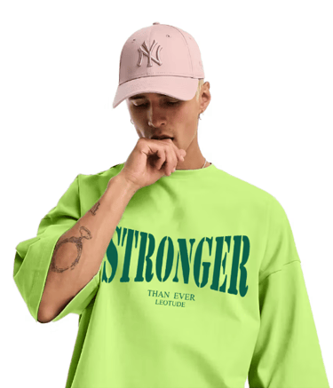 a man in a green shirt and a pink hat