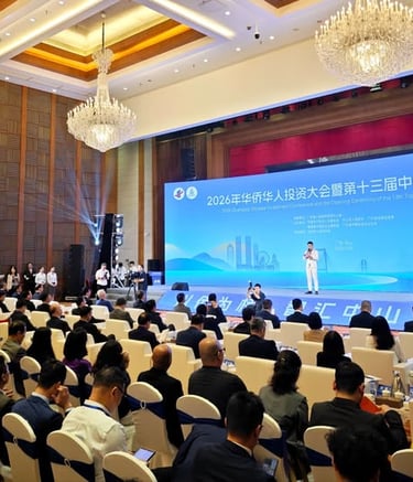 Professional business conference in Zhongshan with attendees seated facing a large blue digital stage display.