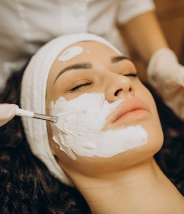 a woman getting a facial in a beauty salon
