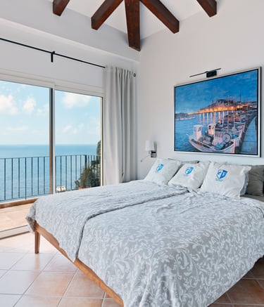 a bedroom with a large painting on the wall