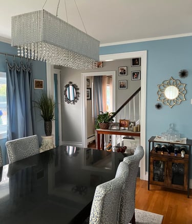 a dining room table with chairs and a chandelier