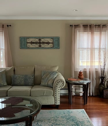 a living room with a couch and chairs