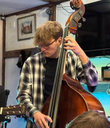 An image of Jamie Walker performing Jazz on his Double Bass