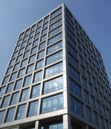 High-angle wide shot of a contemporary corporate building facade in Maharashtra, India, reflecting a clean blue sky. The scene conveys reliability and modern technology, featuring glass windows and polished architecture in tones of dark blue and silver gray.