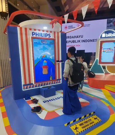 Kid playing digital sack race game using Kinect motion sensor at mall activation