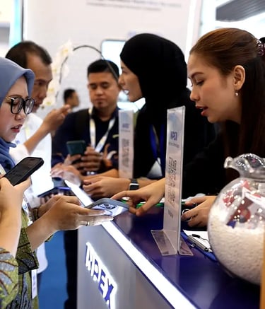 INPEX booth visitors registering via QR code and exploring the interactive zones