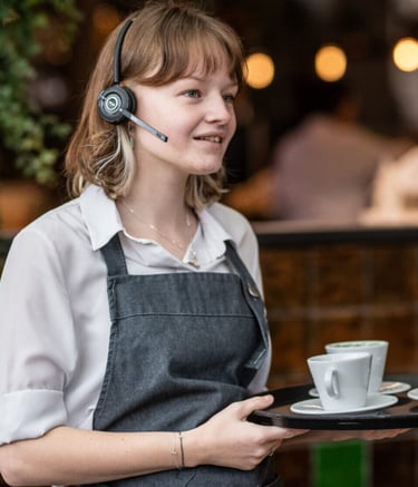 Restaurant waitress with headphones and PoC radio microphone.