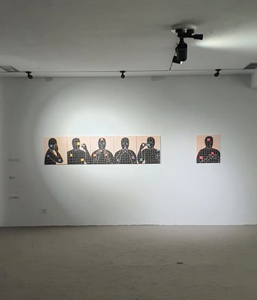 a room with a wall with three paintings on it