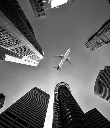 a plane flying over a city with tall buildings