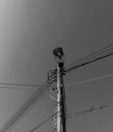 a telegraph pole with lots of communication wires
