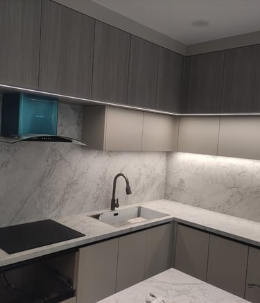 a kitchen with marble counter tops and a sink