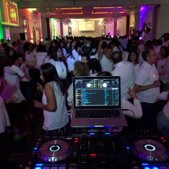DJ setup with laser lights and fog machine at party
