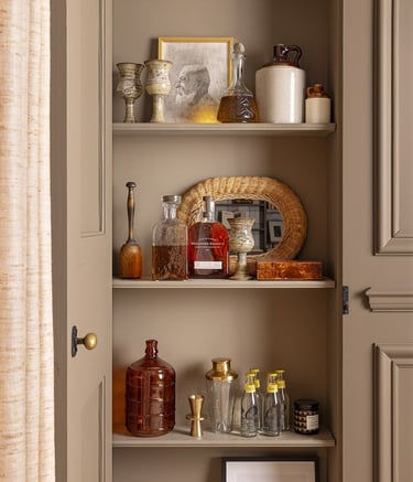 a cabinet with a shelf full of bottles and bottles