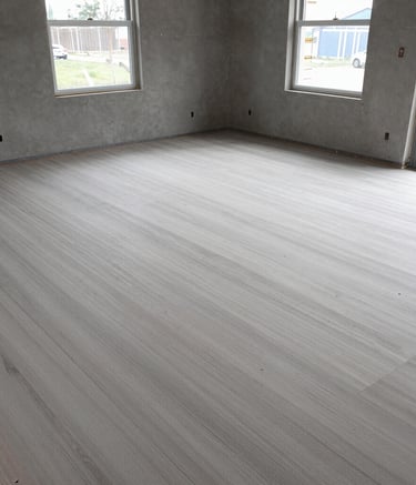 Construction team carefully smoothing new sidewalk surface with tools.