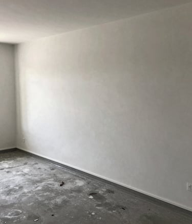 Modern commercial building under construction with visible concrete work and scaffolding.