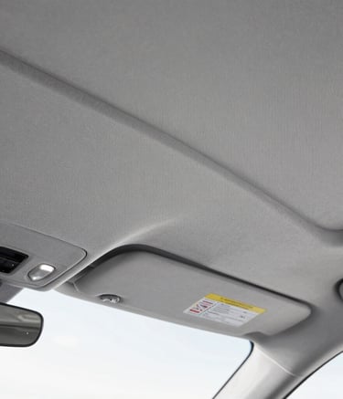 Smooth tan leather car seat with precise stitching