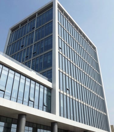 The exterior of a modern commercial office building in Visakhpatnam, India, featuring contemporary glass architecture and clean white lines under a clear, bright sky, reflecting a professional and established brand image.