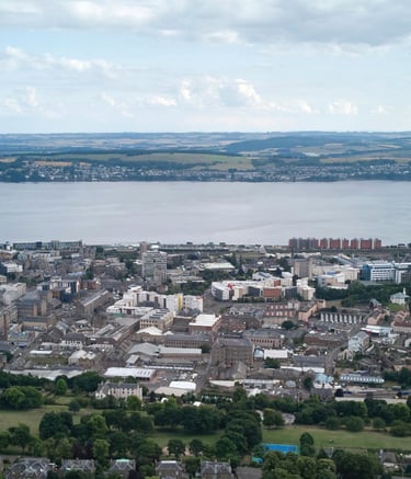 Aerial view of Dundee city skyline and Tay Road Bridge spanning the River Tay in Scotland.