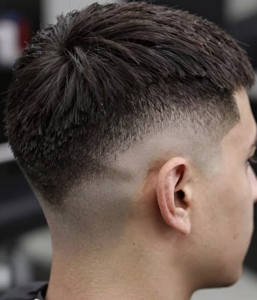 Extreme close-up photography of a perfectly executed skin fade haircut on a man. The focus is on the sharp, precise hairline and the smooth transition. Sophisticated lighting highlights the hair texture in a premium European / Romanian barber shop setting. Colors include dark charcoal and off-white.