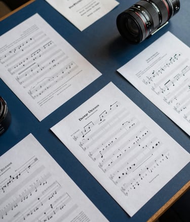 A top-down shot of a strategic planning table with film scripts and sheet music, featuring Deep Ocean Blue accents and Soft Fog paper, sharp focus, professional lighting.
