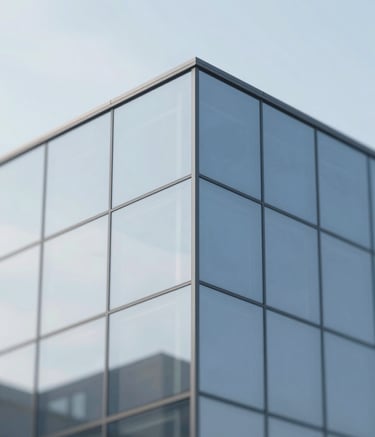 A close-up photograph of a seamless glass corner in a modern architectural building, showcasing extreme precision and clarity. The lighting is natural and bright, with subtle blue-gray reflections of the sky, following the palette of #BCC9D4 and #F7F9FB.